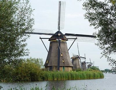 Dutch windmills along a canal.