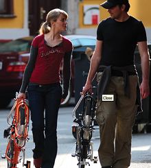 couple walking with folding bikes