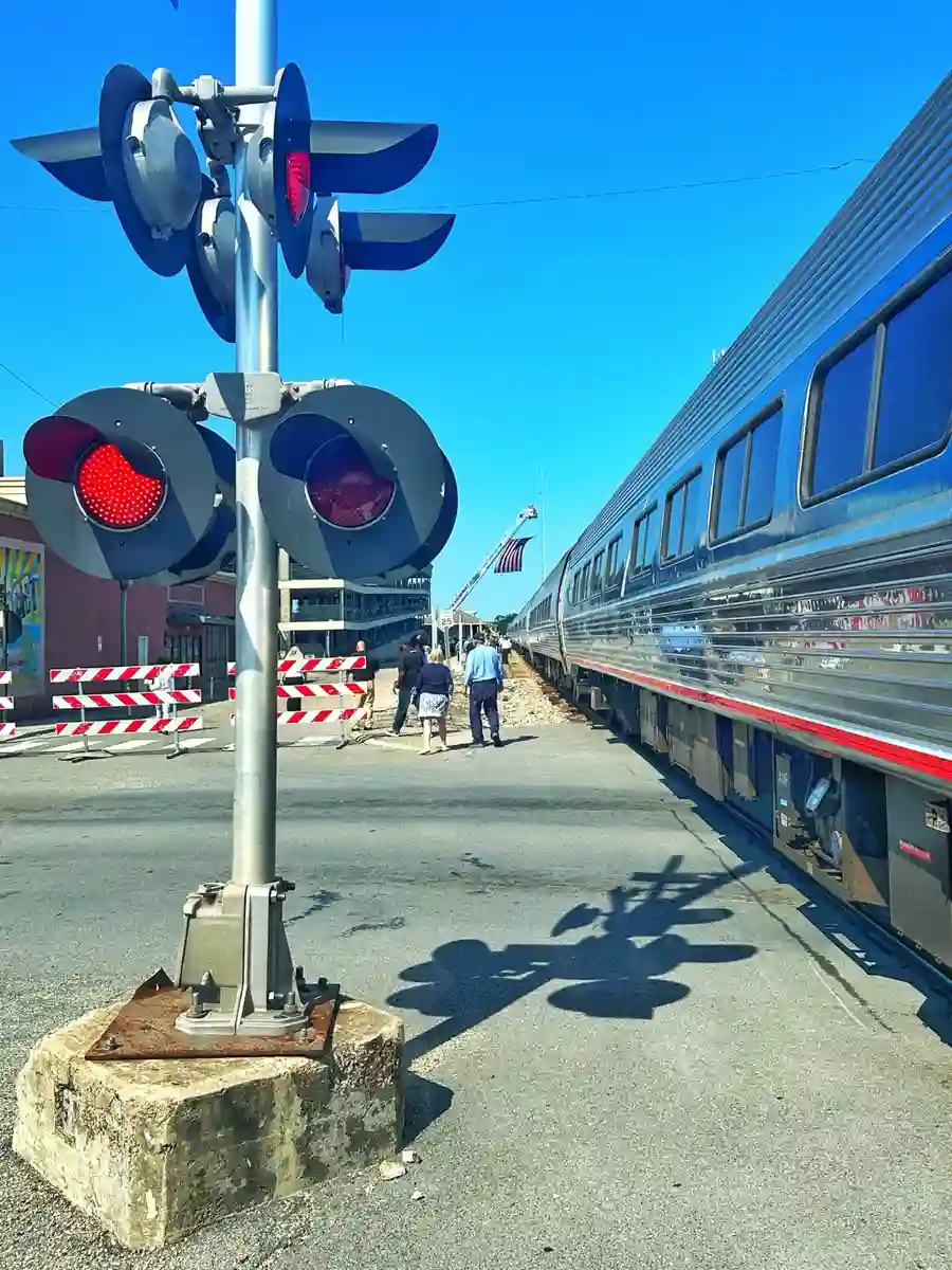 Amtrak train beside a railroad crossing