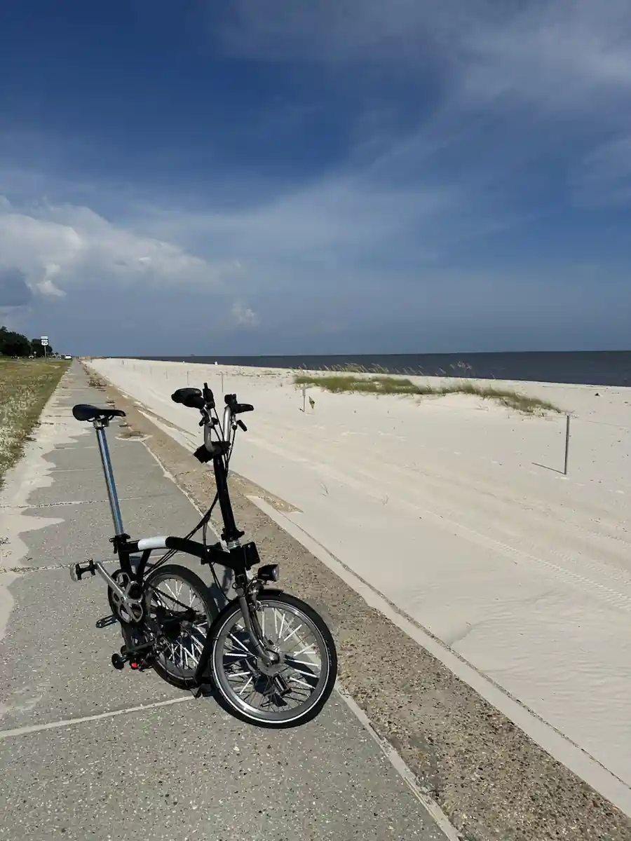 Brompton folding bicycle beside a Gulf Coast beach