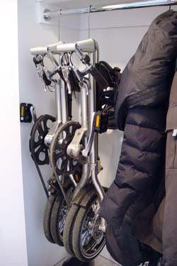 Strida folding bikes stored on a coat rack